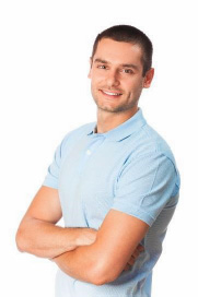 The image features a man standing against a white background, smiling at the camera with his arms crossed. He has short hair, a beard, and is wearing a blue polo shirt with a collar.