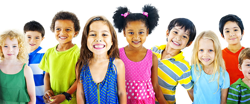 The image depicts a diverse group of children and young adults posing for a photo with smiles on their faces.